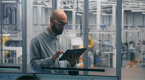 Manufacturing facility quality inspectors reviewing production process with machinery and equipment